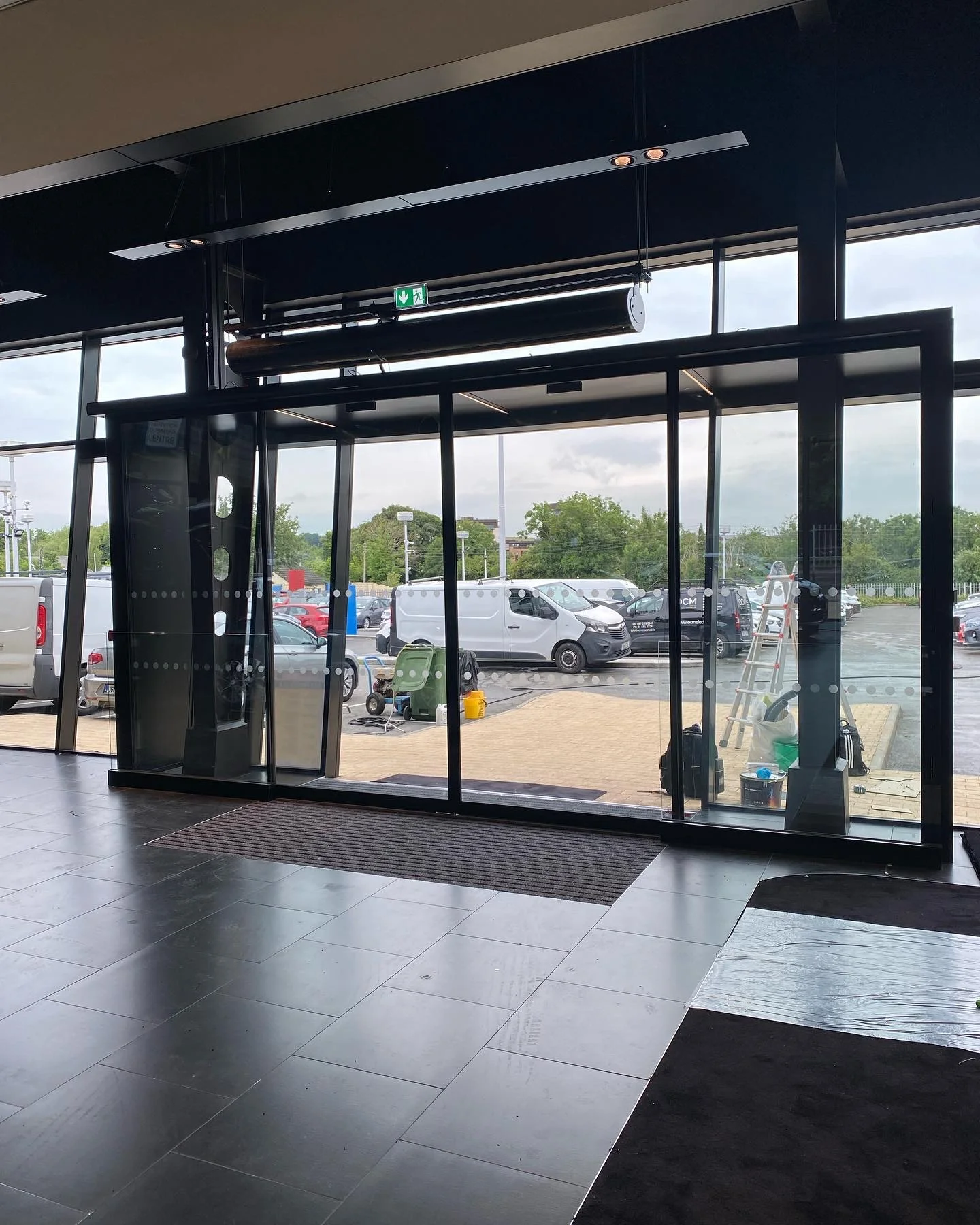 Black aluminium automatic sliding glass door installation commercial showroom Ireland